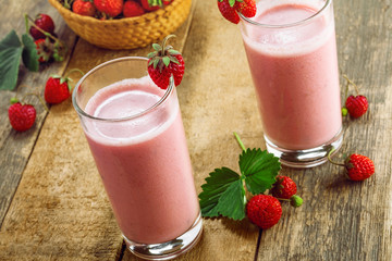 Delicious fruit milkshake made of fresh ripe strawberry and milk. Diet drink for healthy breakfast.