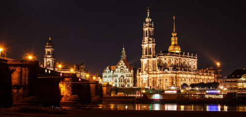 Fototapeta na wymiar Night summer beautiful panoramic view of Cathedral of the Holy Trinity or Hofkirche, Bruehl's Terrace or the Balcony of Europe on Elbe river, Dresden, Saxony, Germany, Europe.