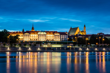 Night view of the Royal Castle and Vistula river in Warsaw, Poland