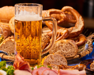 Ein Glas Bier, mit Brezen verschiedenen Würsten und Gebäckrustikal angerichtet Oktoberfest