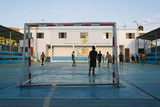 Boys playing soccer on the court