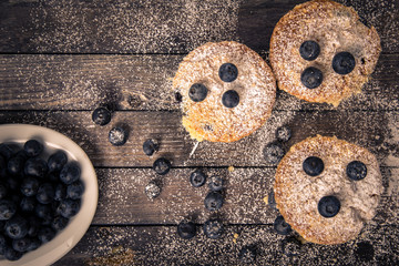 blueberry muffin, wood background, top view