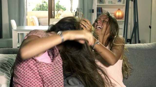 Sisters on sofa fighting hard pulling long hair strong color correction  Stock Video | Adobe Stock