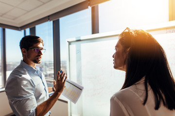 Entrepreneurs in office discussing business ideas.