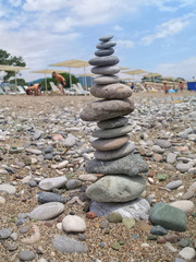 Sea pebbles piled up in pyramid on the beach for inner peace.