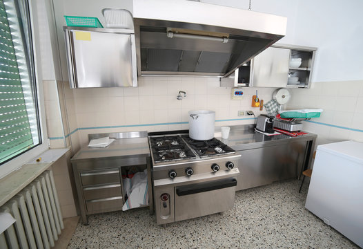 commercial kitchen with oven in steel stainless and a big pot