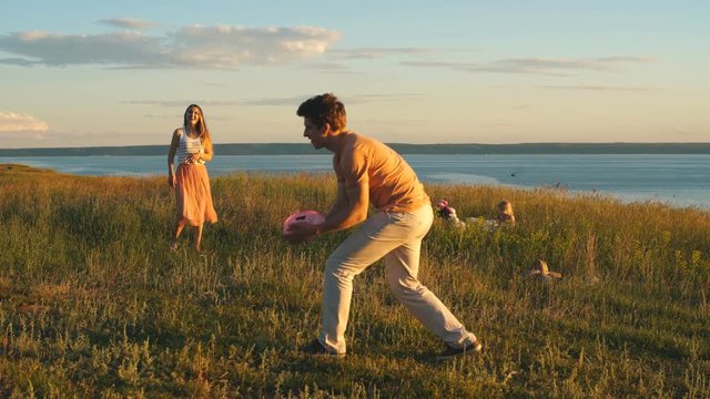 happy couple playing Frisbee
