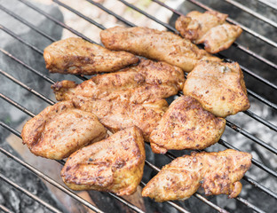 Grilling chicken breast on barbecue grill 