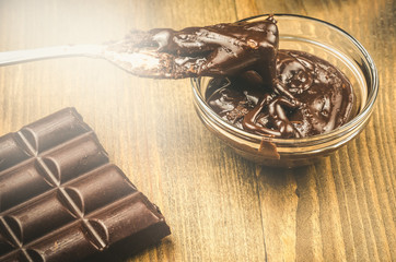 wooden spoon in chocolate.   wooden spoon in chocolate. Toned