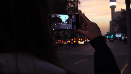 Tourist taking a photo on La Alameda, is the main avenue of Santiago, Chile