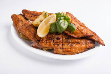 Grilled mackerel with lemon on a white background