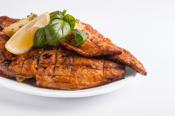 Grilled mackerel with lemon on a white background