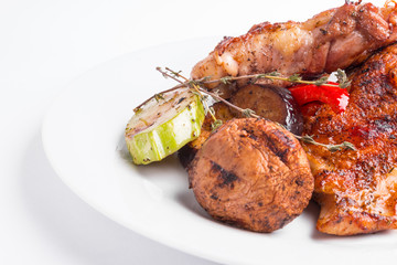 Grilled chicken steak and vegetables on a white background