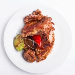 Grilled chicken steak and vegetables on a white background