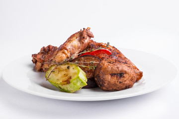 Grilled chicken steak and vegetables on a white background