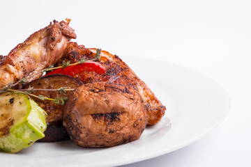 Grilled chicken steak and vegetables on a white background