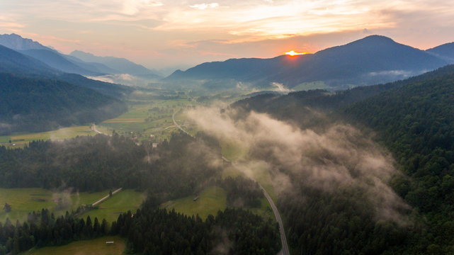 Aerial view of sunrise over a valley.