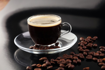Coffee cup and coffee beans on table