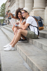 young tourist couple reading online city guide