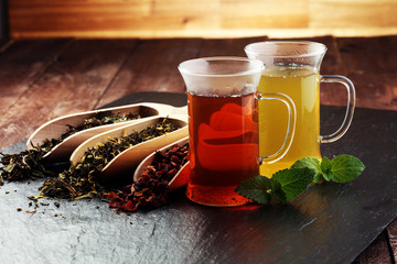Tea. Herbal tea. Mint leaf. Tea in a glass cup, mint leaves, dried, sliced lime. herbs on a slate plate in a restaurant or teahouse