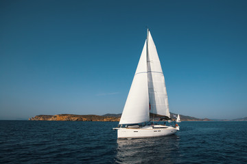Fototapeta na wymiar Luxury yacht boat at Regatta. Sailing in the wind through the waves at the Sea.