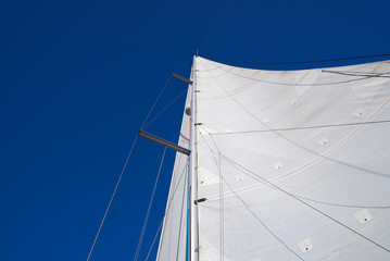 white sail against the blue sky
