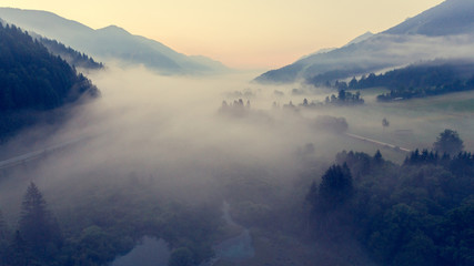 Aerial view mist hovering across a valley.
