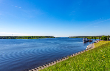 Fototapeta na wymiar The shore of the grandiose Russian Volga river near the town of Mishkin on a summer day. Yaroslavl region 