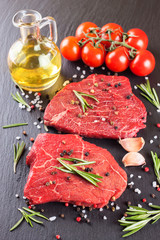 raw steak with cooking ingridients