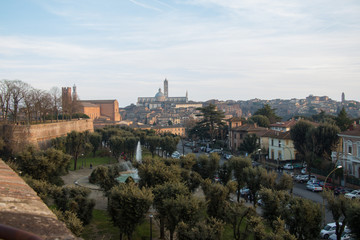 Fototapeta na wymiar Public park and Duomo di Siena on background. Viem from Medici fortress. Tuscany. Italy.