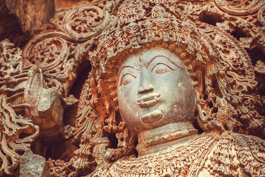 Face of Shiva Lord sculpture on wall of old relief. 12th centur Hindu Hoysaleshwara temple in Halebidu, India