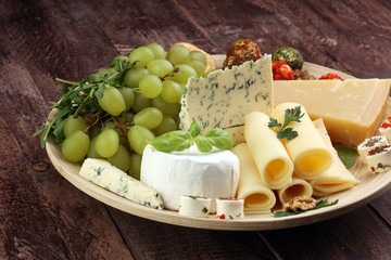 Cheese platter with different cheese and grapes