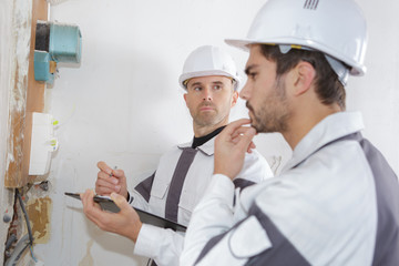 professional electrician installing components in electrical shield