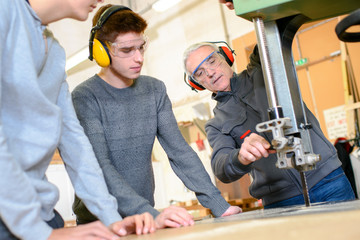 carpenter instructor with students in workshop