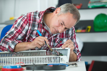 repairman fixing radiator in his workplace