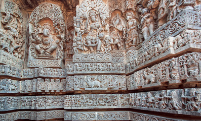 Ganesha, Shiva, Vishnu lords on relief of great Indian temple. Architecture of ancient temples of Halebidu, with carved walls made in 12th century. Hoysaleshwara temple, India.