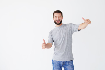 Portrait of young man holding thumbs up