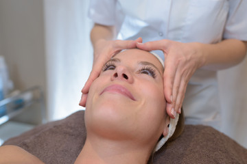 Obraz na płótnie Canvas young attractive girl having head massage at spa resort