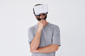 Handsome bearded male using VRG making thinking gesture