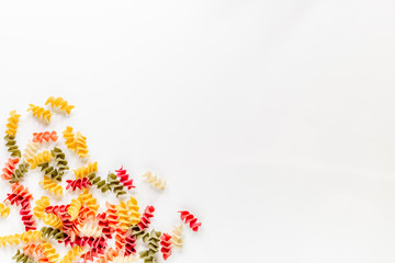 Fusilli pasta on white background top view copyspace