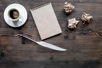 Writer concept. Feather pen, vintage notebook and crumpled paper on wooden table background top view copyspace mockup