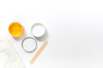 Wax and stick for depilation on white background top view copyspace