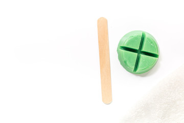 Wax and stick for depilation on white background top view copyspace