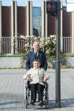 old couple walks on the pedestrian crossing