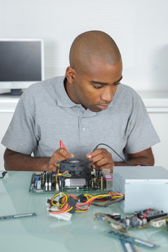 repairman working on electronic components