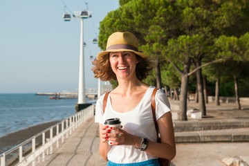 Attractive young woman walking in Lisbon near Tajus river at Park of the Nations