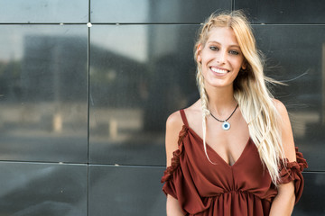 happy beautiful blonde woman smiling looking at the camera and posing