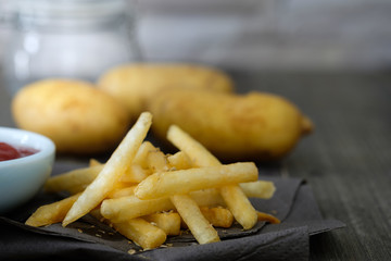 Fresh fried french fries with ketchup on wooden background Choose focus point.