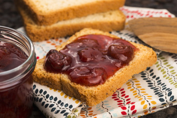 Breakfast of cherry jam on toast