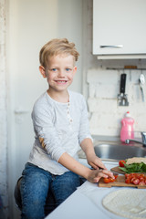 Handsome boy is cooking in the kitchen at home. Healthy food